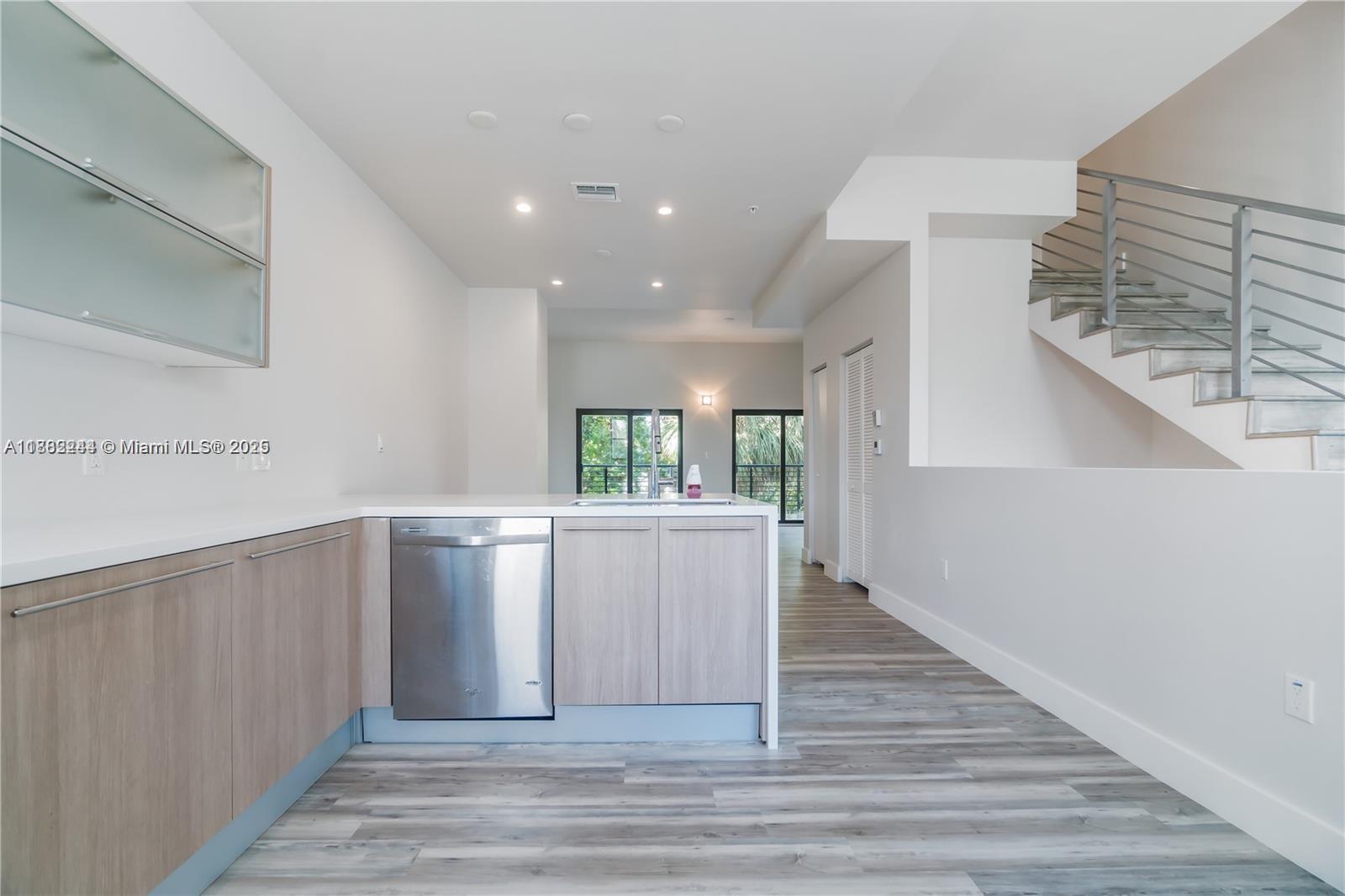 532 Southeast 1st Circle Pompano Beach, FL 33060 - Photo 11 of 57 a view of a kitchen with wooden floor and staircase