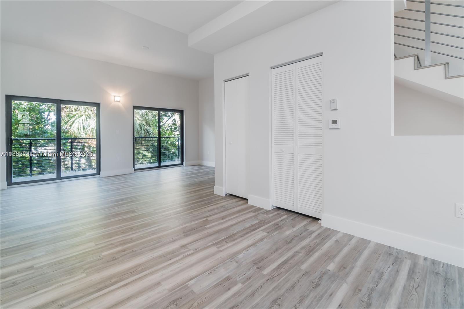 532 Southeast 1st Circle Pompano Beach, FL 33060 - Photo 17 of 57 an empty room with wooden floor and windows