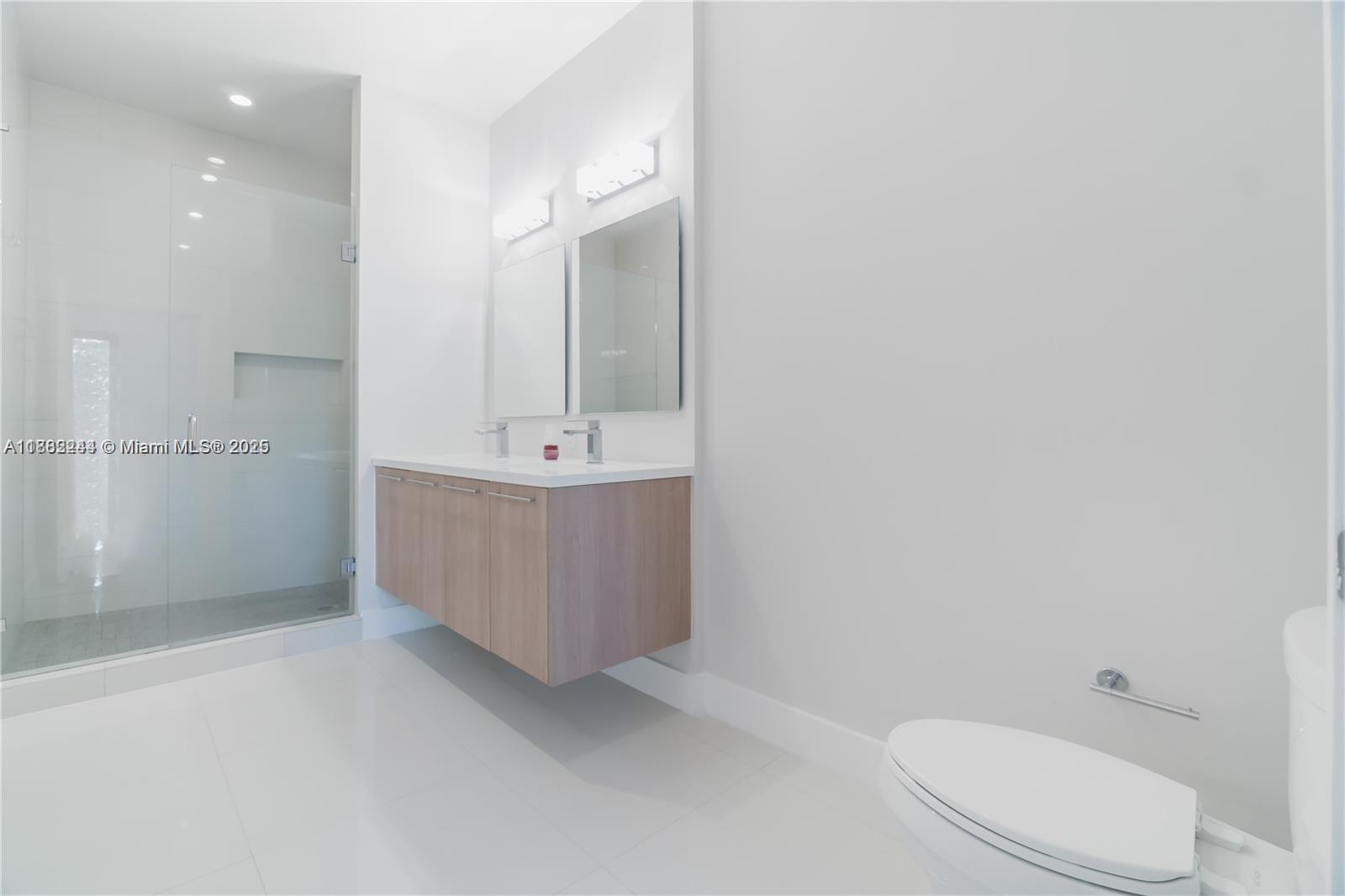 532 Southeast 1st Circle Pompano Beach, FL 33060 - Photo 24 of 57 a bathroom with a sink a toilet and mirror