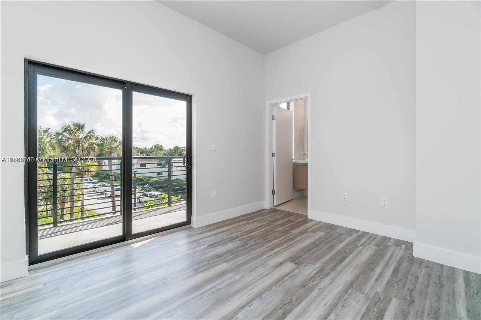 532 Southeast 1st Circle Pompano Beach, FL 33060 - Photo 27 of 57 a view of an empty room with wooden floor and a window