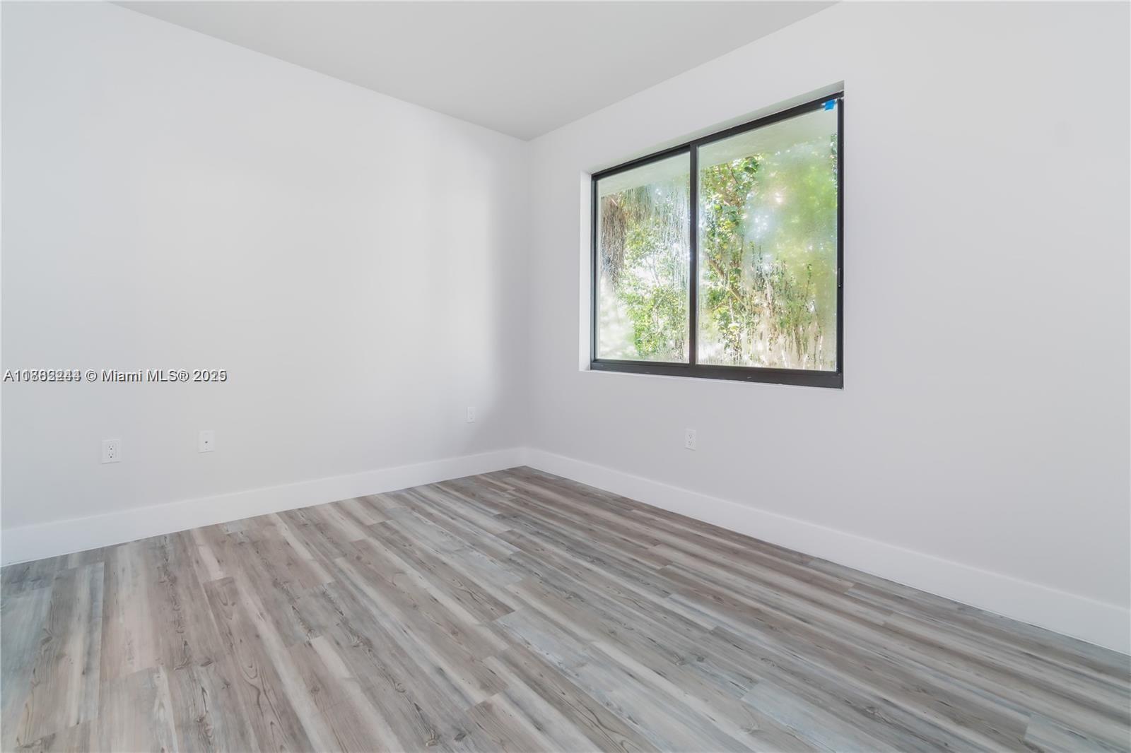 532 Southeast 1st Circle Pompano Beach, FL 33060 - Photo 28 of 57 an empty room with wooden floor and windows