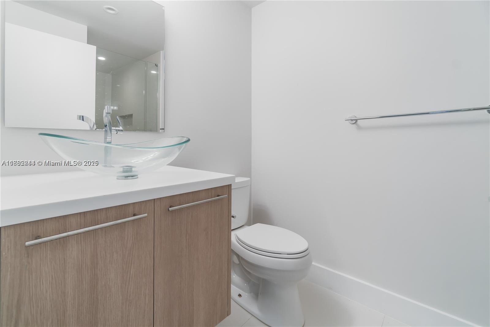 532 Southeast 1st Circle Pompano Beach, FL 33060 - Photo 32 of 57 a bathroom with a sink a toilet and a mirror