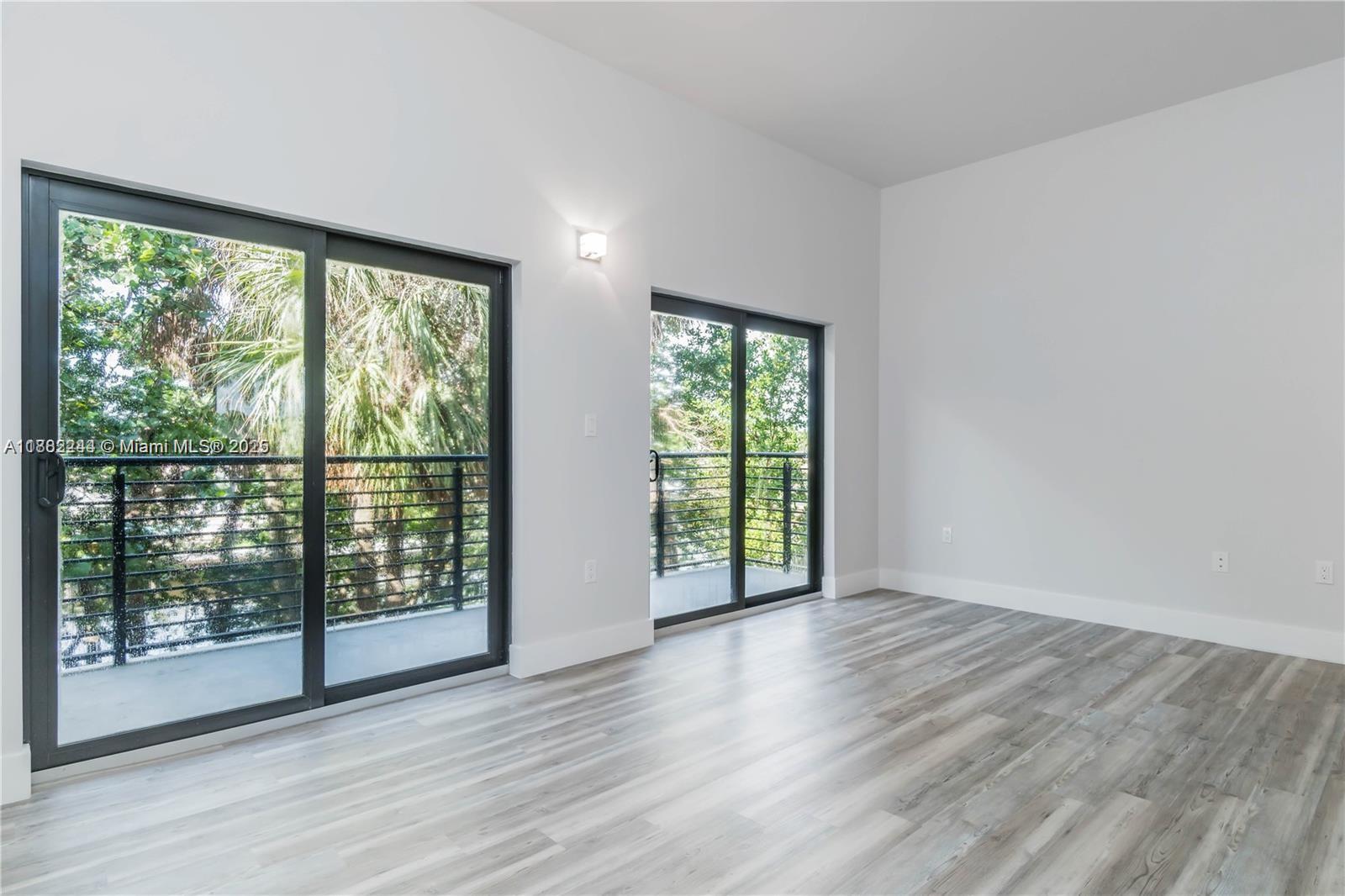 532 Southeast 1st Circle Pompano Beach, FL 33060 - Photo 38 of 57 a view of an empty room with wooden floor and a window