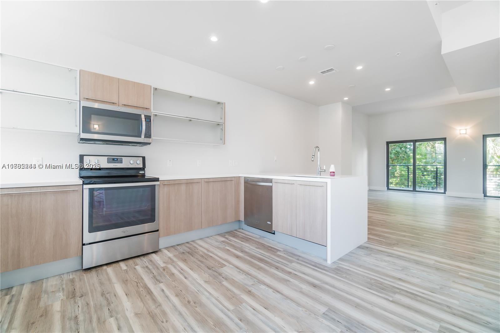 532 Southeast 1st Circle Pompano Beach, FL 33060 - Photo 5 of 57 a kitchen with a refrigerator and a stove top oven