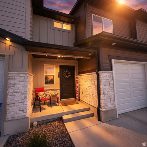 3047 Old Emigrant Road, Unit C Syracuse, UT 84075 - Photo 1 of 20 Entrance to property with board and batten siding, stone siding, a porch, and a garage