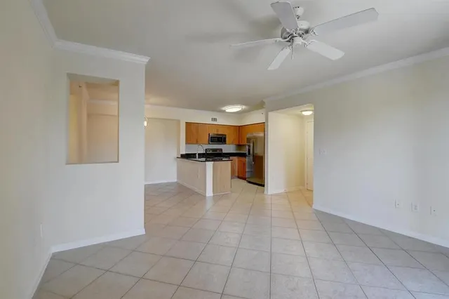 a view of kitchen with granite countertop cabinets and refrigerator