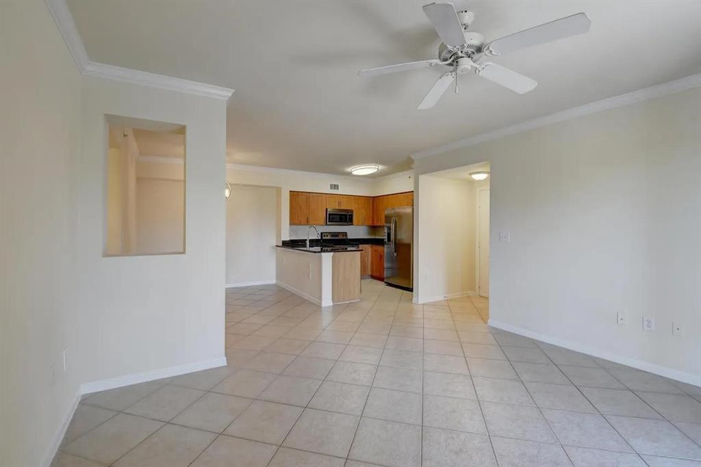 6565 Emerald Dunes Drive, Unit 301 West Palm Beach, FL 33411 - Photo 12 of 32 a view of kitchen with granite countertop cabinets and refrigerator