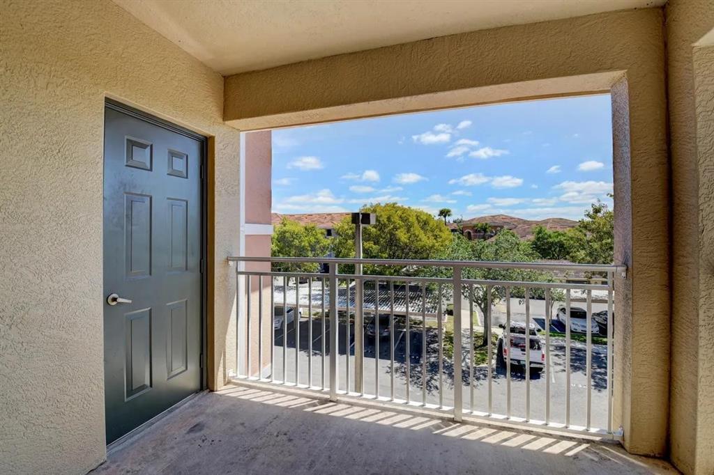6565 Emerald Dunes Drive, Unit 301 West Palm Beach, FL 33411 - Photo 14 of 32 a view of a balcony with lake view