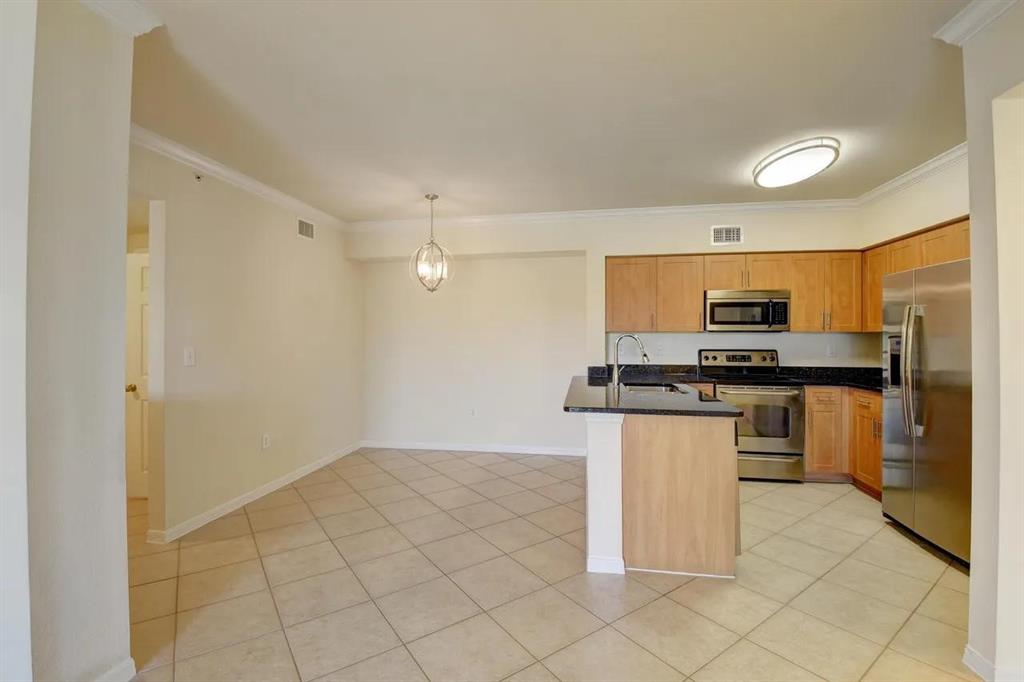 6565 Emerald Dunes Drive, Unit 301 West Palm Beach, FL 33411 - Photo 17 of 32 a kitchen with stainless steel appliances a refrigerator sink and microwave
