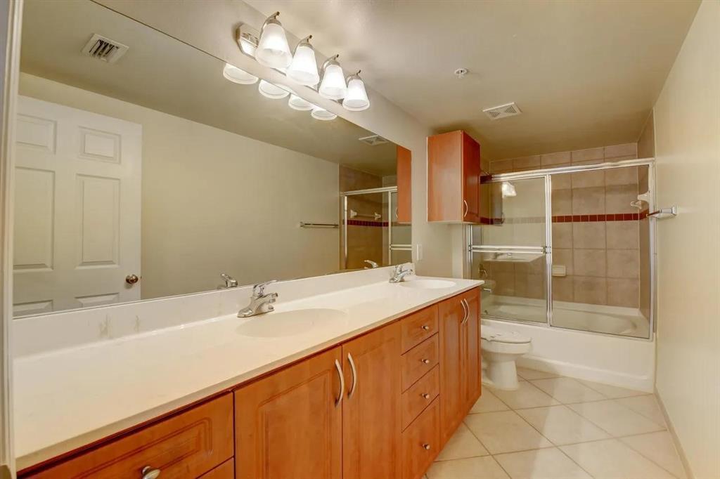 6565 Emerald Dunes Drive, Unit 301 West Palm Beach, FL 33411 - Photo 21 of 32 a bathroom with a sink a toilet and shower