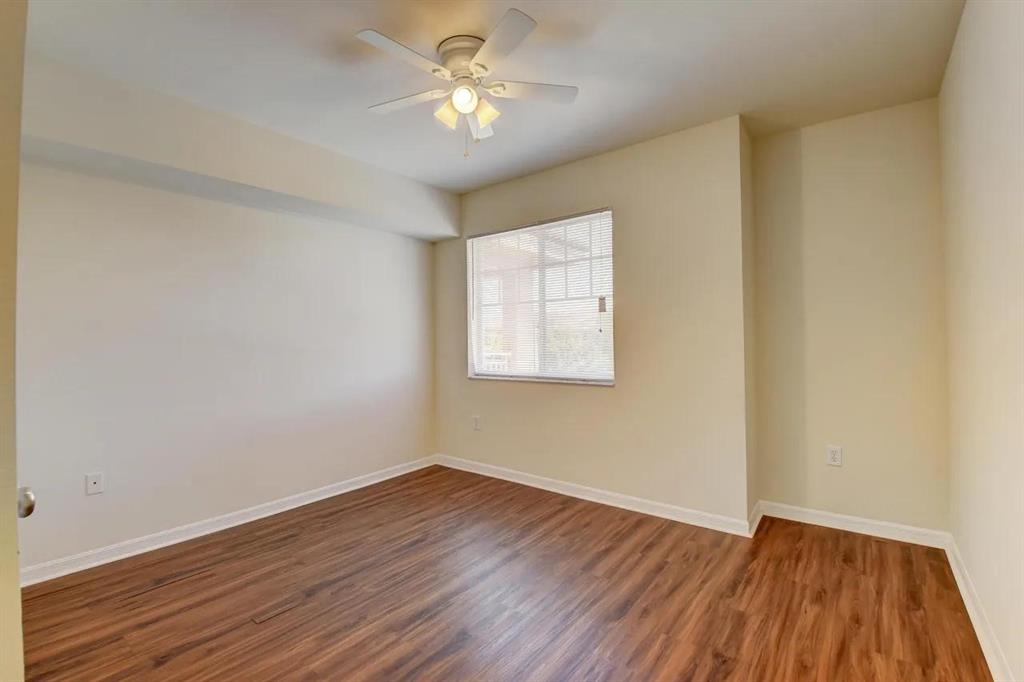 6565 Emerald Dunes Drive, Unit 301 West Palm Beach, FL 33411 - Photo 23 of 32 a view of empty room with wooden floor and fan