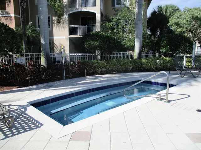 a view of backyard with wheel chair potted plants and palm trees