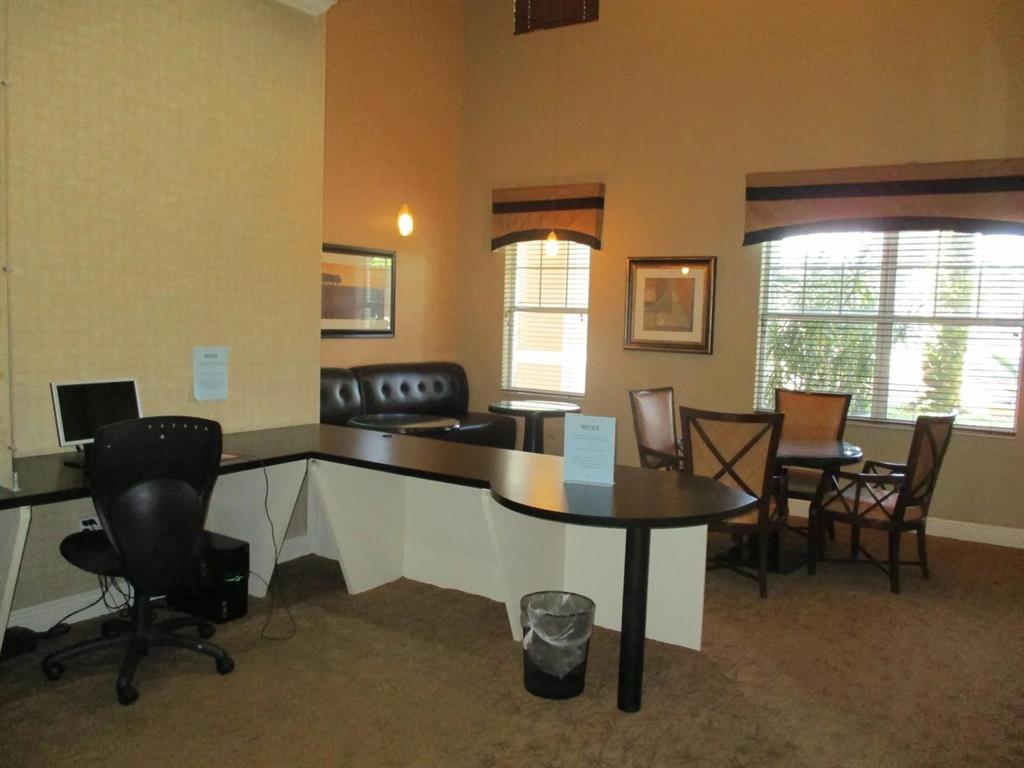 6565 Emerald Dunes Drive, Unit 301 West Palm Beach, FL 33411 - Photo 30 of 32 a view of a workspace with furniture and a window