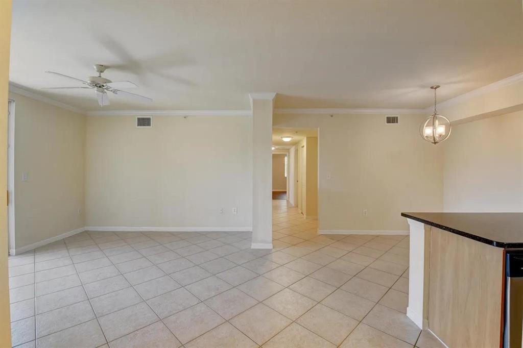 6565 Emerald Dunes Drive, Unit 301 West Palm Beach, FL 33411 - Photo 8 of 32 a view of an empty room and chandelier fan