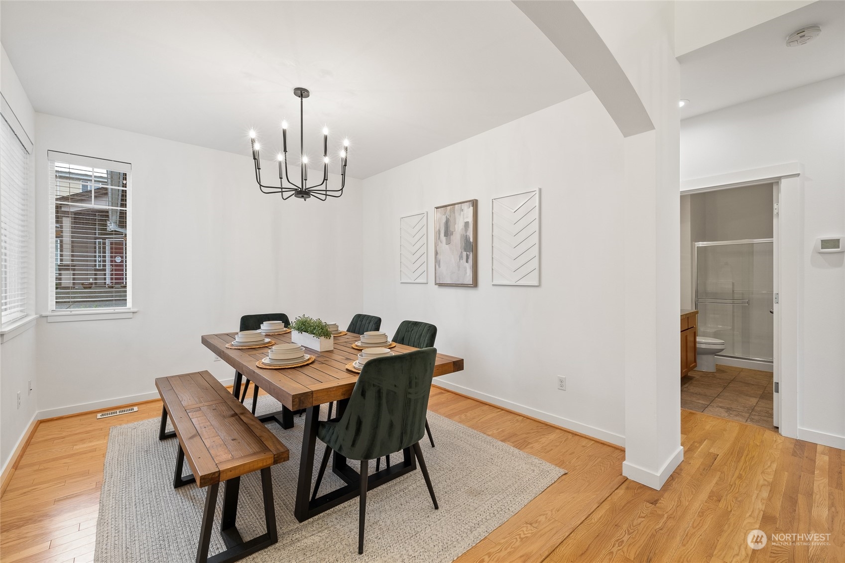 4022 222nd Place Southeast Bothell, WA 98021 - Photo 11 of 40 a dining room with furniture a chandelier and wooden floor