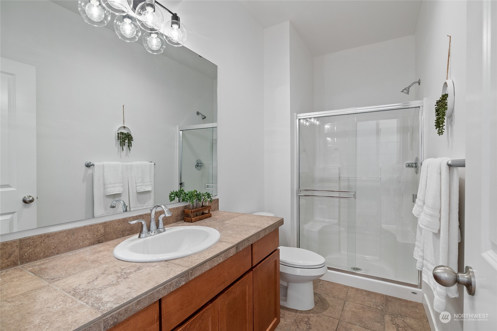 4022 222nd Place Southeast Bothell, WA 98021 - Photo 12 of 40 a bathroom with a granite countertop sink toilet a mirror and shower