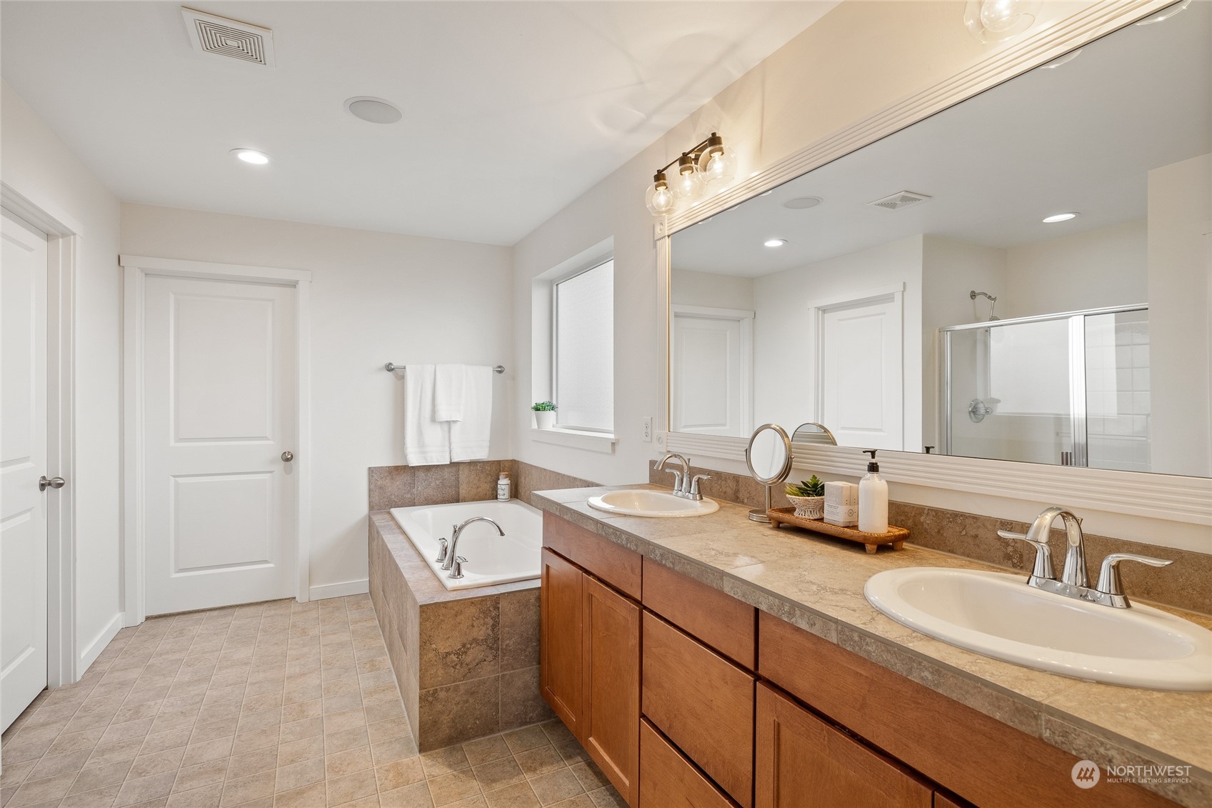 4022 222nd Place Southeast Bothell, WA 98021 - Photo 16 of 40 a spacious bathroom with a double vanity sink and mirror