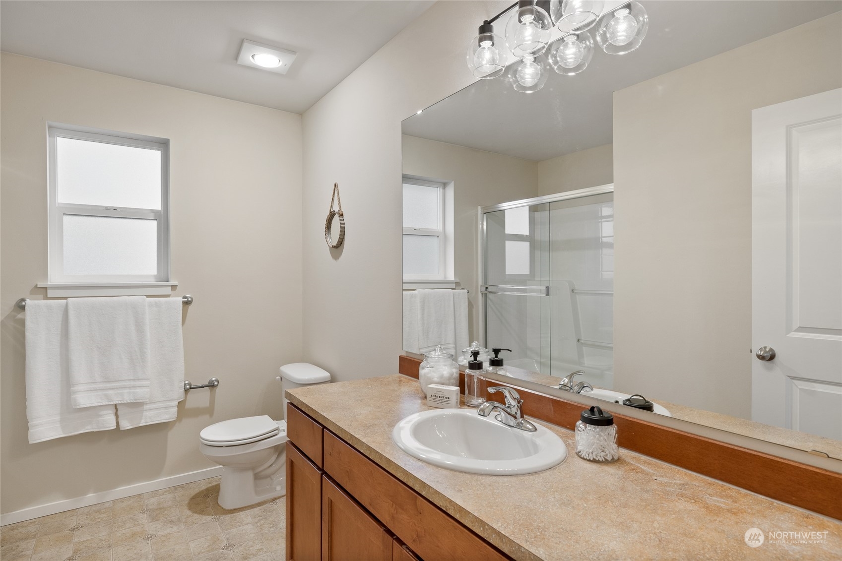 4022 222nd Place Southeast Bothell, WA 98021 - Photo 21 of 40 a bathroom with a granite countertop toilet a sink and a mirror