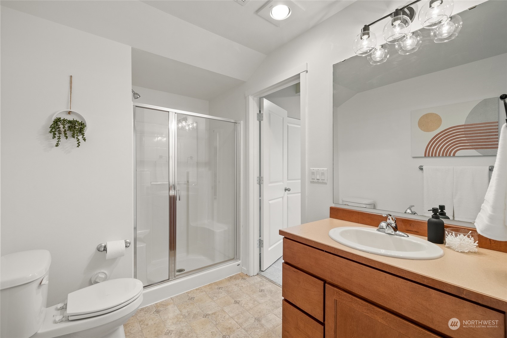 4022 222nd Place Southeast Bothell, WA 98021 - Photo 29 of 40 a bathroom with a granite countertop sink a toilet and shower