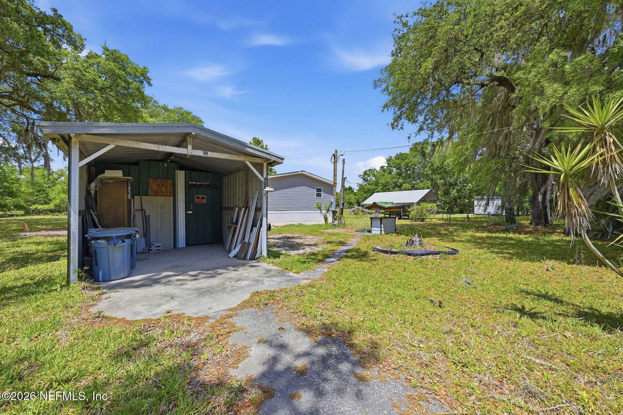 101 Oakhaven Road Pomona Park, FL 32181 - Photo 21 of 23 a view of a chair and table in backyard of the house