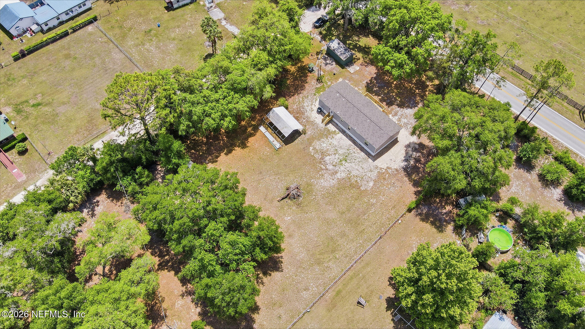 101 Oakhaven Road Pomona Park, FL 32181 - Photo 23 of 23 an aerial view of a house with a yard and trees all around