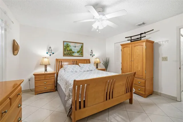 a bedroom with a bed and a table in it with window