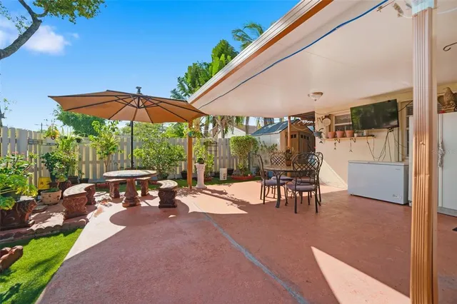 a front view of a house with a tree