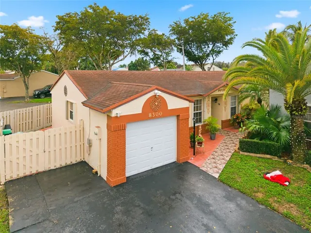 a kitchen with stainless steel appliances kitchen island granite countertop a refrigerator and a stove top oven