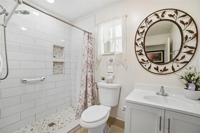 a kitchen with stainless steel appliances granite countertop a stove top oven a sink dishwasher a dining table and chairs with wooden floor