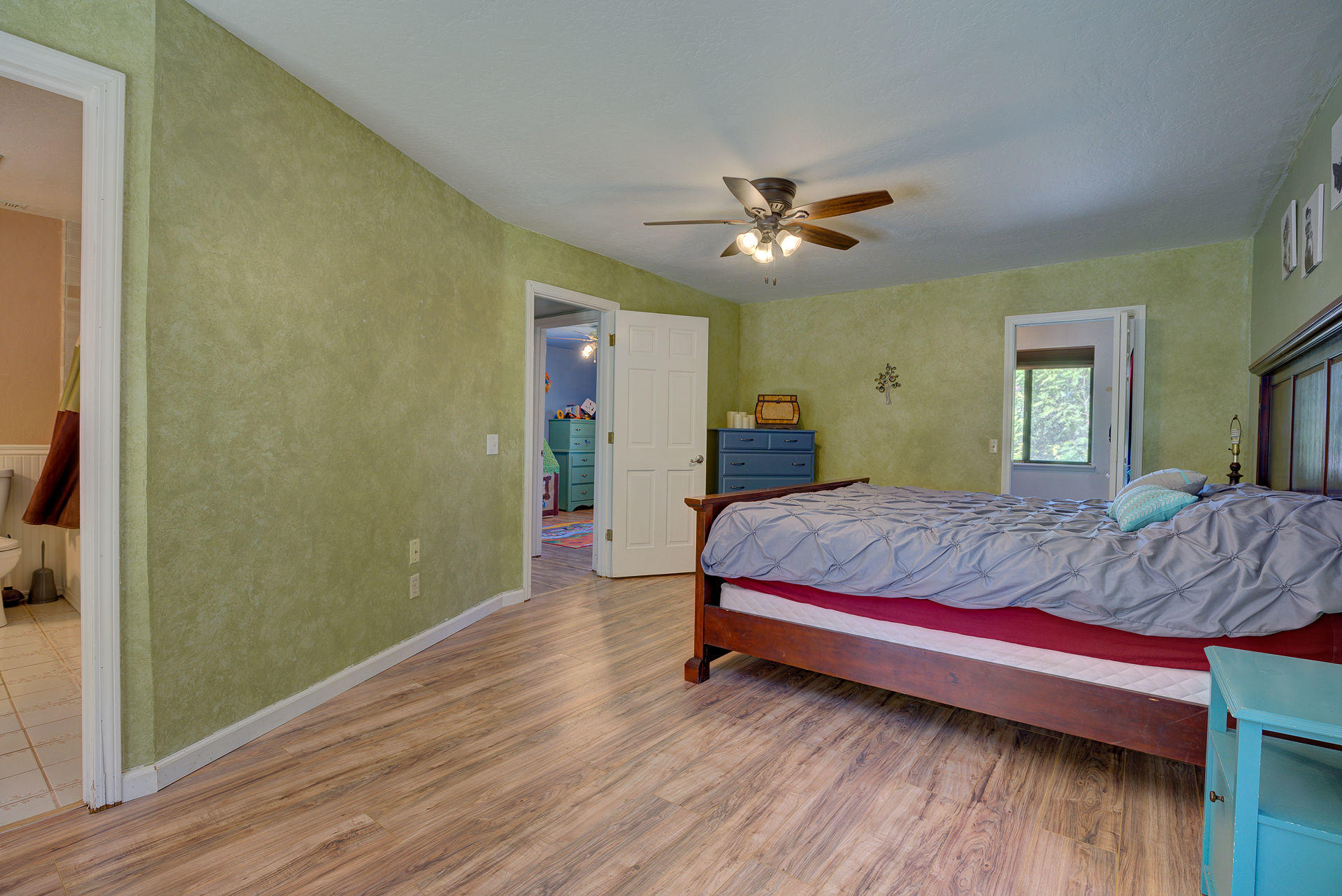12814 Williamson Road Redding, CA 96003 - Photo 14 of 39 a bedroom with a bed and a chandelier
