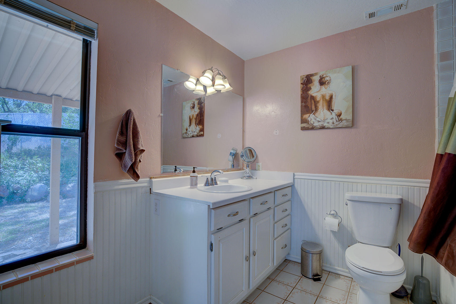 12814 Williamson Road Redding, CA 96003 - Photo 16 of 39 a bathroom with a toilet a sink a vanity and mirror