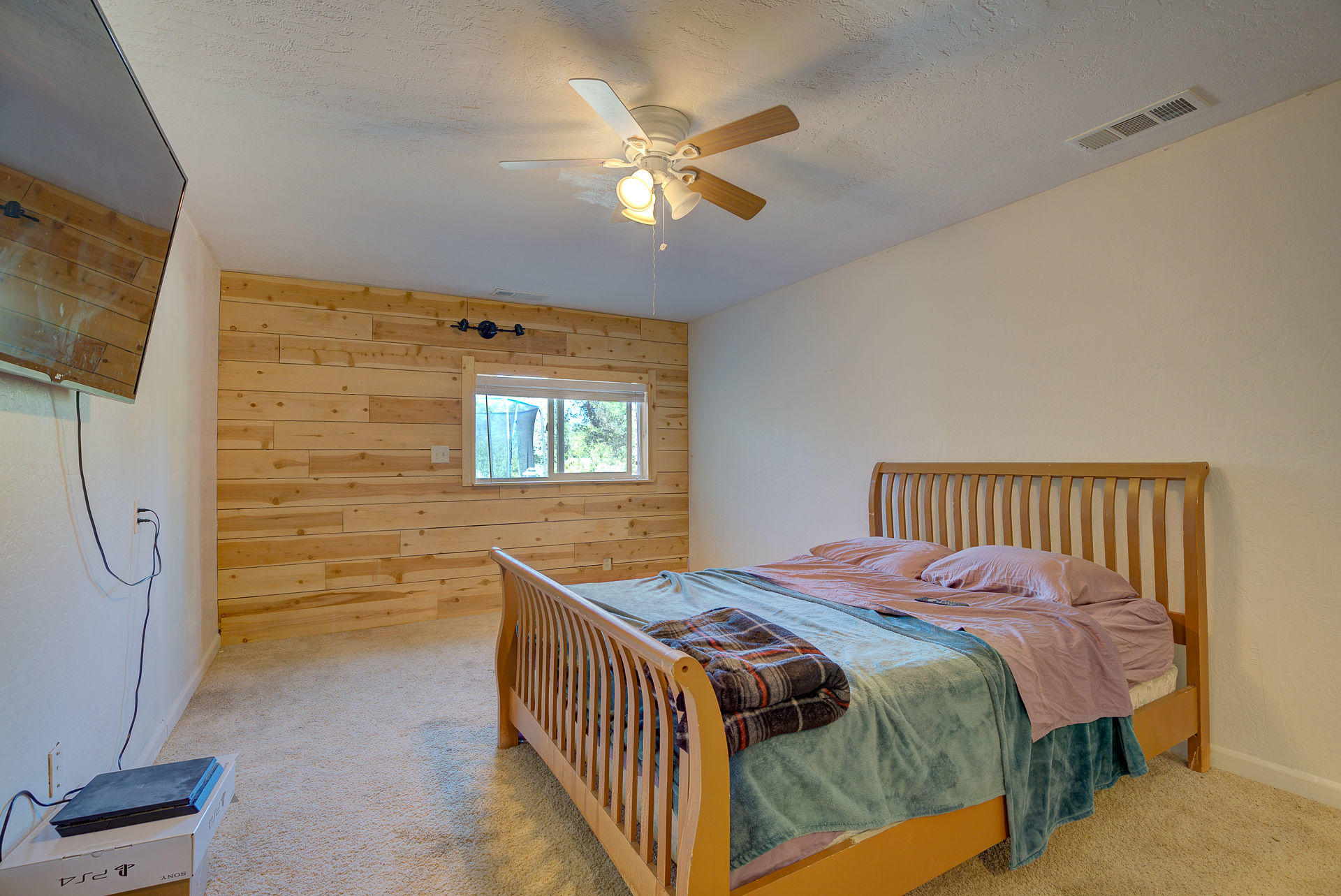 12814 Williamson Road Redding, CA 96003 - Photo 17 of 39 a bedroom with a bed and a flat screen tv