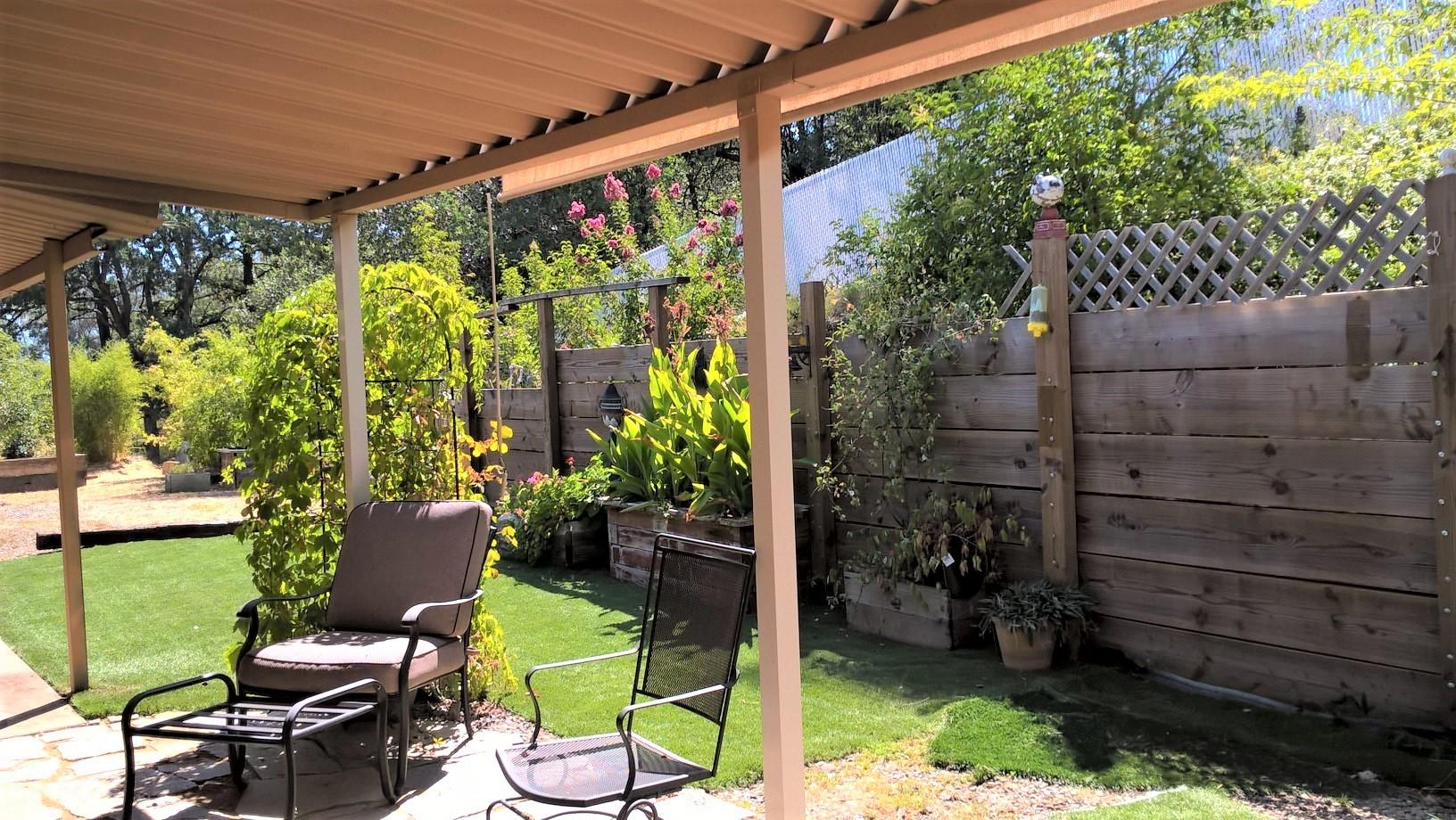 12814 Williamson Road Redding, CA 96003 - Photo 22 of 39 a view of a chair and table in backyard
