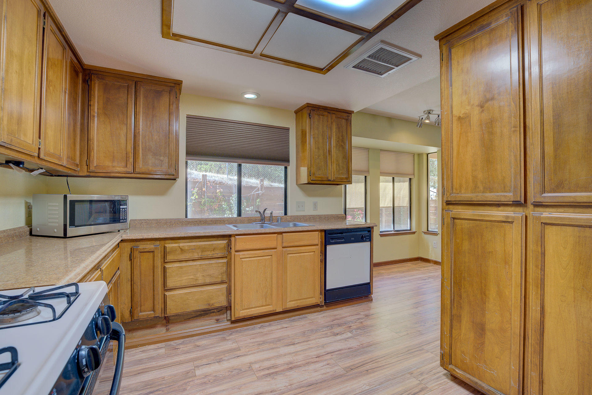 12814 Williamson Road Redding, CA 96003 - Photo 25 of 39 a kitchen with stainless steel appliances granite countertop wooden cabinets a sink and a refrigerator