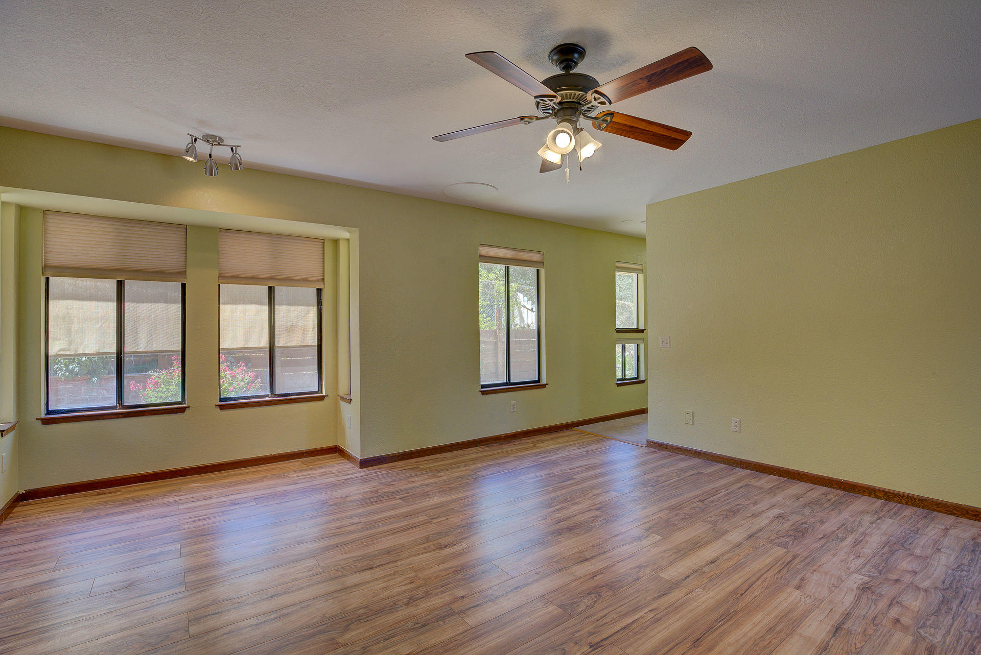 12814 Williamson Road Redding, CA 96003 - Photo 28 of 39 a view of an empty room with wooden floor and a window