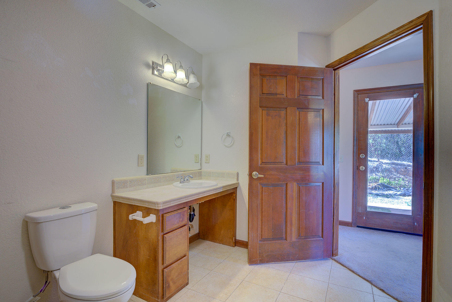 12814 Williamson Road Redding, CA 96003 - Photo 33 of 39 a bathroom with a granite countertop toilet and a sink