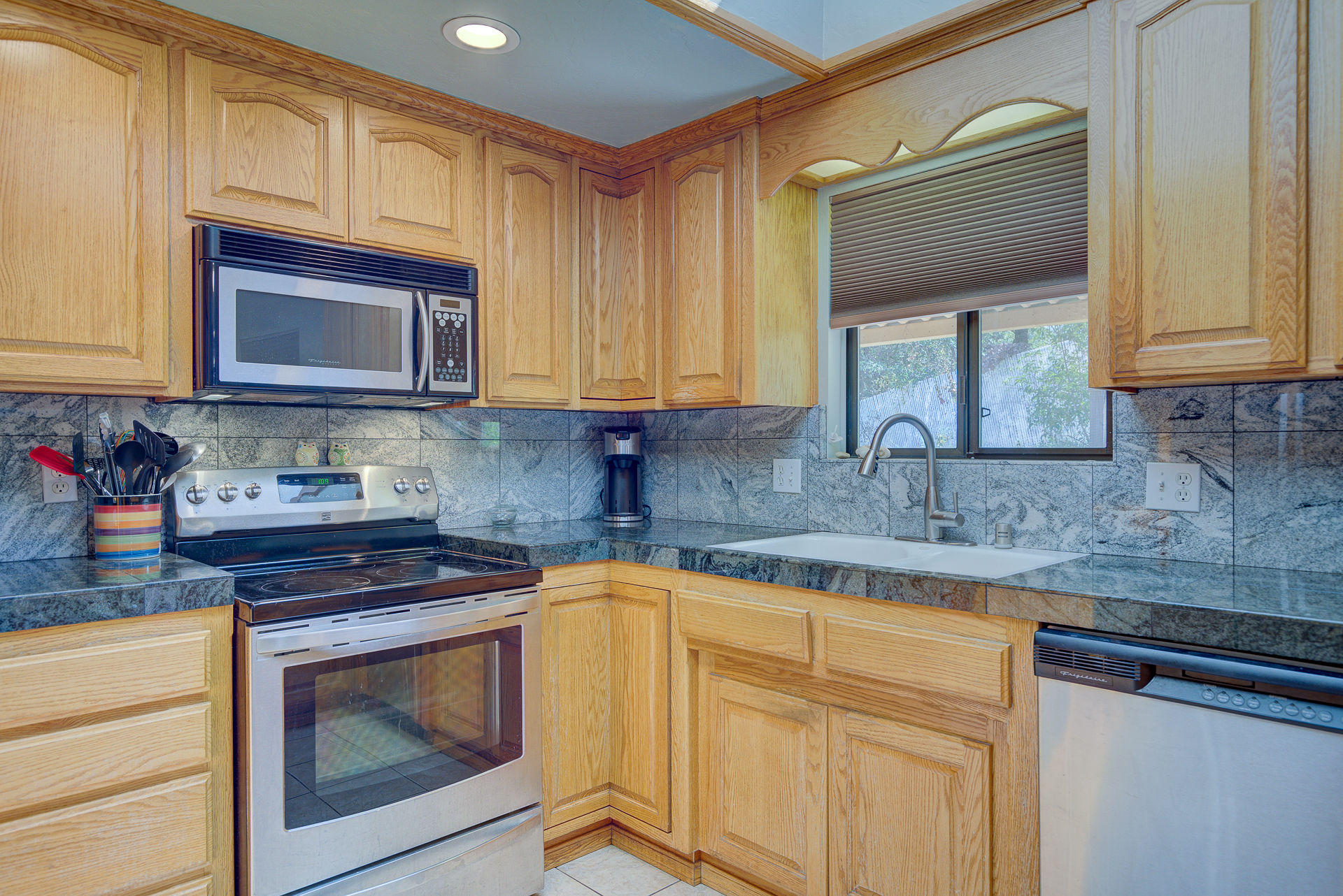 12814 Williamson Road Redding, CA 96003 - Photo 6 of 39 a kitchen with granite countertop cabinets stainless steel appliances a sink and a counter space