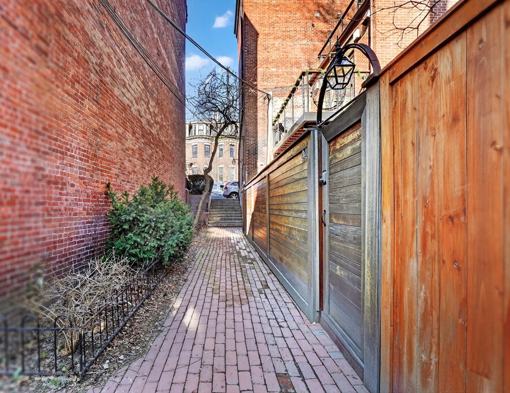 42 Clarendon Street, Unit 1 Boston, MA 02116 - Photo 25 of 26 a view of a pathway with a wooden door
