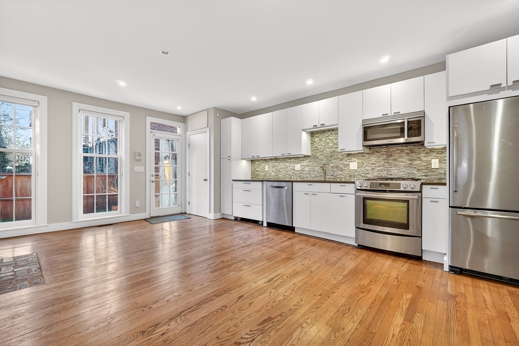 42 Clarendon Street, Unit 1 Boston, MA 02116 - Photo 4 of 26 a kitchen with stainless steel appliances granite countertop a refrigerator and a stove top oven