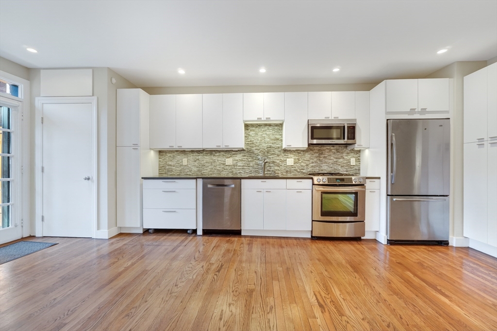42 Clarendon Street, Unit 1 Boston, MA 02116 - Photo 6 of 26 a kitchen with stainless steel appliances granite countertop a refrigerator and a stove top oven