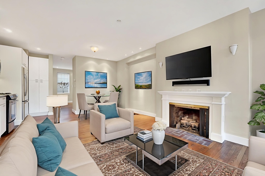 42 Clarendon Street, Unit 1 Boston, MA 02116 - Photo 7 of 26 a living room with furniture a flat screen tv and a fireplace