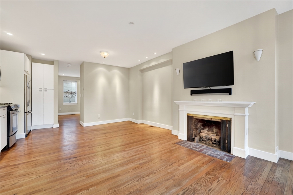 42 Clarendon Street, Unit 1 Boston, MA 02116 - Photo 8 of 26 a view of empty room with wooden floor and fireplace