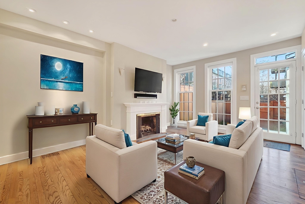 42 Clarendon Street, Unit 1 Boston, MA 02116 - Photo 10 of 26 a living room with furniture a fireplace and a flat screen tv