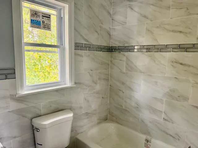 a bathroom with a shower and a toilet