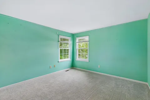 a room with furniture and air conditioner vent