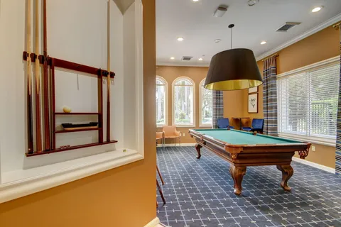 a living room with fireplace furniture and a large window