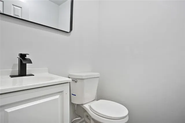 a white toilet sitting next to a sink