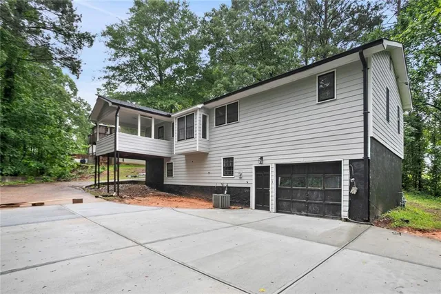 a front view of a house with yard and trees