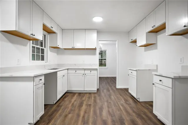 a kitchen with cabinets a sink and wooden floor
