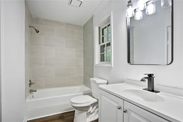 a bathroom with a sink a toilet and bathtub